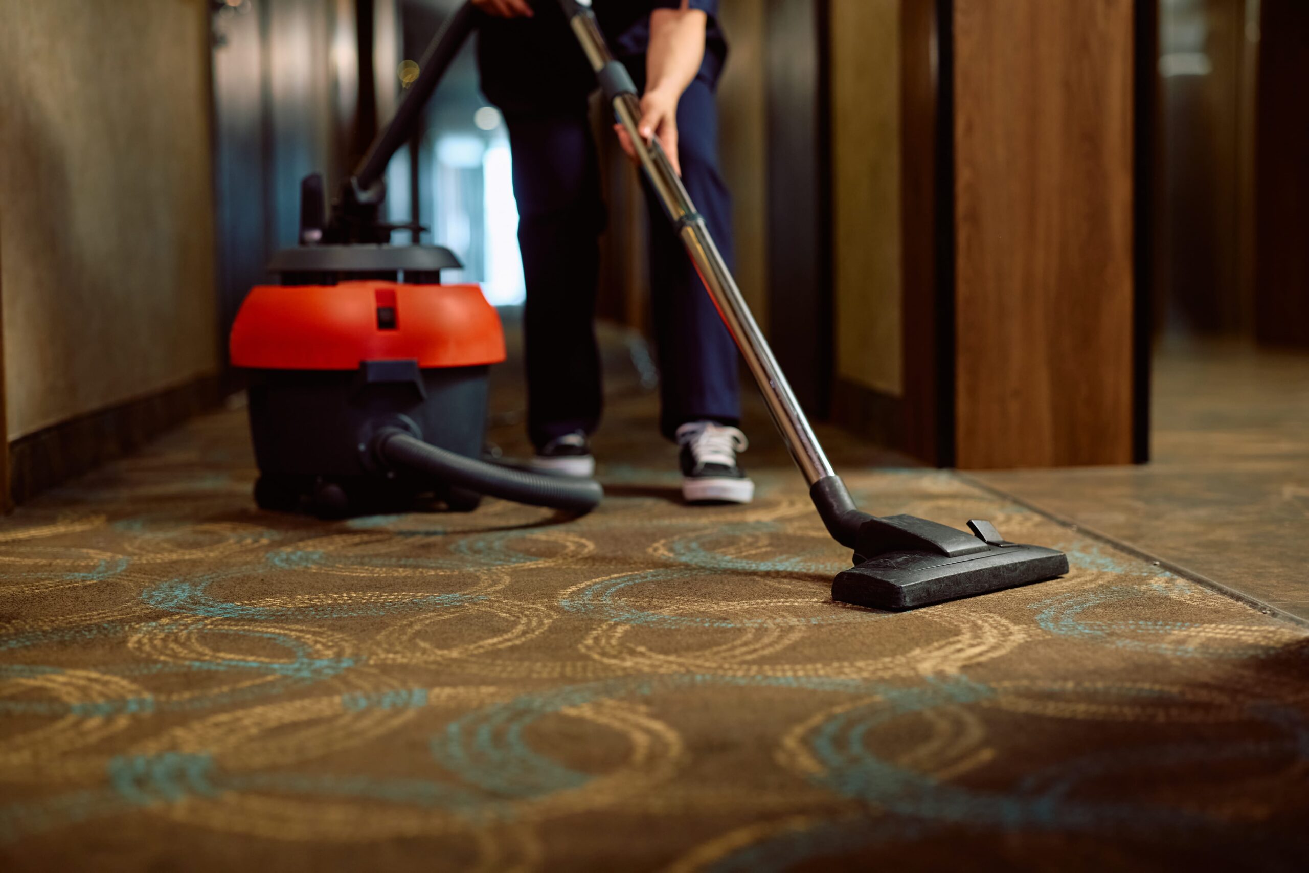 close up of hotel maid vacuuming the hallway 2024 12 13 17 08 46 utc min scaled